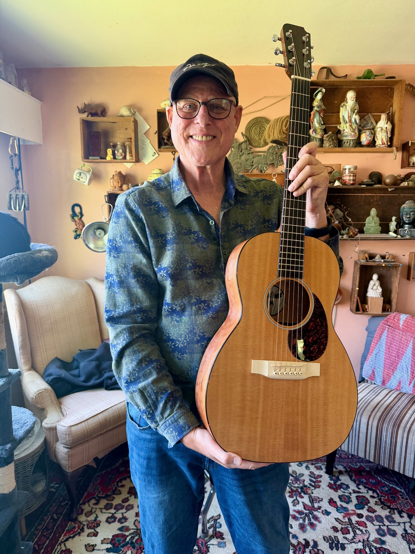 Shambhu holding his custom Oracle Guitar, handcrafted by master luthier Todd Johnston